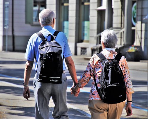 Active senior couple walking outdoors in India morning